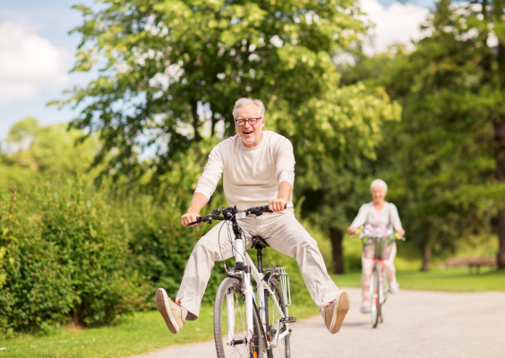 Elderly man having fun on bicycle